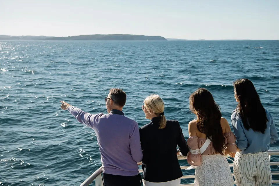 Passengers watching from an outside deck